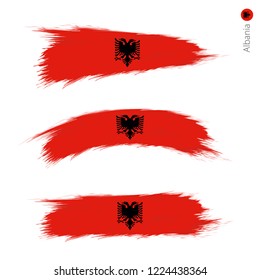 Set of 3 grunge textured flag of Albania, three versions of national country flag in brush strokes painted style. Vector flags.