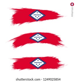 Set of 3 grunge textured flag of US State Arkansas, three versions of state flag in brush strokes painted style. Vector flags.