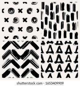 Set of 4 abstract vector seamless patterns with various shapes made with brush strokes. Hand-drawn grunge ink wallpapers. Creative repeating backgrounds.