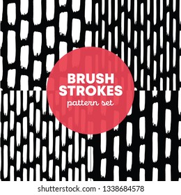 Set of 4 brush vertical stroke seamless patterns. Seamless white doodle watercolor ornament on black. Grunge scribble thick strokes in vertical rows on black. Maded for different cards and packaging.