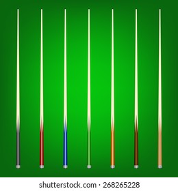 Set of 7  different billiard cues on a green background. 