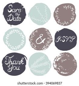 Set of 9 decorative wedding and romantic elements. Watercolour hand drawn circles with grungy lettering and floral decorations. Trendy black, brown and blue shapes with rough edges isolated on white