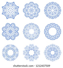 Set of 9 hand-drawn symmetrical blue frosty icy snowflakes complex mandalas.