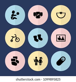 Set of 9 newborn filled icons such as baby socks, diaper, child bicycle, newborn child, family photo, baby toy, couple with newborn