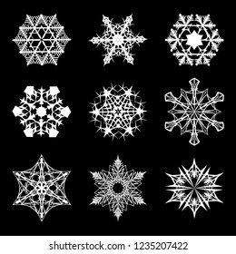 Set of 9 various shapes of Snowflakes. Intricate star-like crystall silhouettes isolated on black background. EPS10 vector illustration