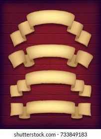 Set of aged paper ribbons on a dark wooden background. Curved old banners. Textured old paper scrolls. Eps10 vector