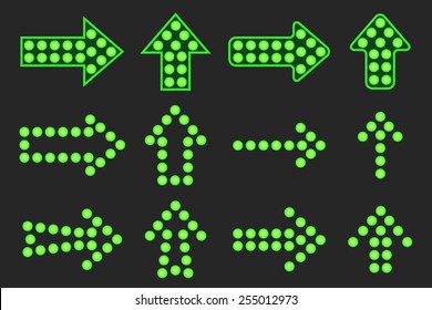 Set of arrows of green light on a black background.