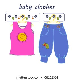A set of baby clothes, bodysuits, shorts on a white background. Knitted clothes for kids. Children's clothing on hangers.