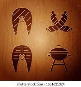 Set Barbecue grill, Fish steak, Fish steak and Crossed sausage on wooden background. Vector