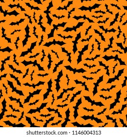 Set of bats silhouettes flying isolated on orange background