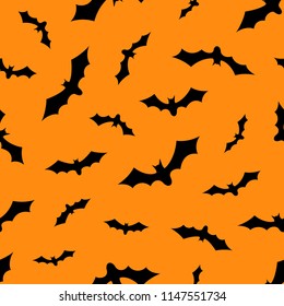 Set of bats silhouettes flying isolated on orange background