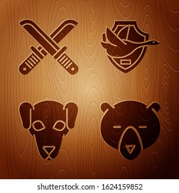 Set Bear head, Crossed hunter knife, Hunting dog and Flying duck on shield on wooden background. Vector