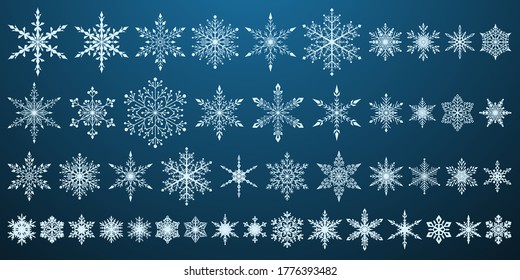 Conjunto de hermosos complejos copos de nieve navideños, blanco sobre fondo azul