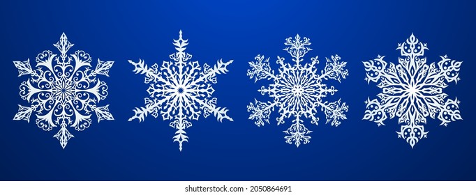 Satz schöner, komplexer Weihnachtsschneeflocken, weiß auf blauem Hintergrund