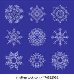 Set of Beautiful Openwork Snowflakes. White Snowflakes on Blue Background.  Elements for Christmas and New Year Design. Vector Illustration.
