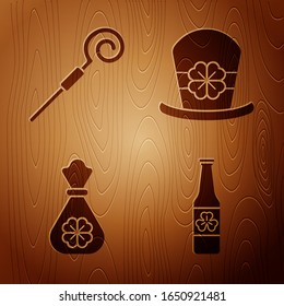 Set Beer bottle with four leaf clover, Walking stick, Money bag with four leaf clover and Leprechaun hat and four leaf clover on wooden background. Vector