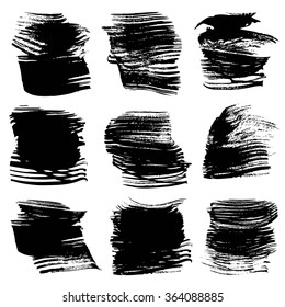 Set of big black abstract textured strokes isolated on a white background