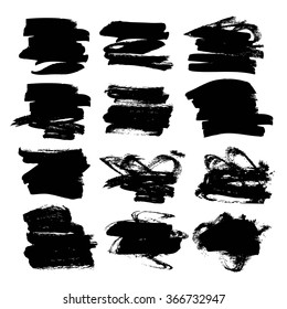 Set of big black textured strokes drawn by flat brush isolated on a white background