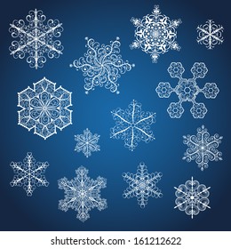 Set of big white snowflakes various forms on blue background