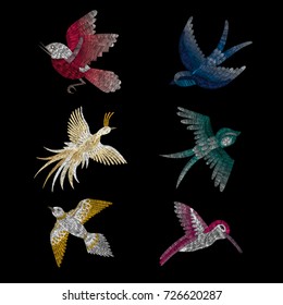 set of birds. crane, firebird, sparrow. traditional stylish fashionable embroidered embroidery on a black background. sketch for printing on fabric, bag, clothes, accessories and design. trend vector