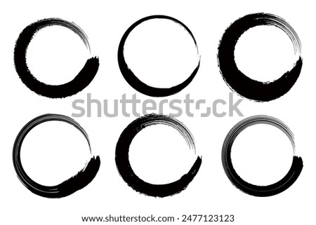 A set of black circles drawn with a brush.