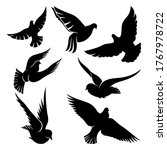 Set of black doves in flight on a white background.