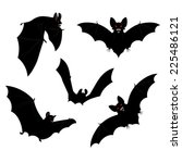 Set of black halloween bats silhouettes with red eyes.