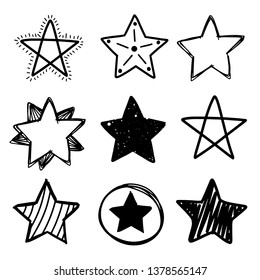 Set of black hand drawn doodle stars in isolated on white background.