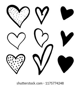 Set of black hand drawn hearts on white background. Design elements for Valentine's day. Hand-drawn painted hearts for t-shirt print, flyer, poster design. Vector illustration.