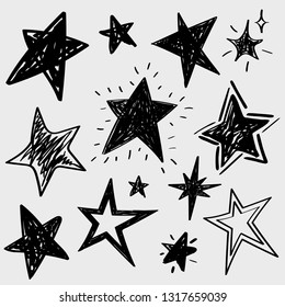 Set of black hand drawn vector stars in doodle style isolated on white background. Could be used as pattern element, cards, childish design