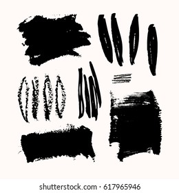 A set of black ink brush strokes, isolated on white background. Hand drawn graphic design elements with copy-space.