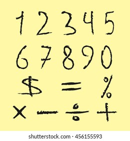 Set of black numbers and mathematical signs. Figures drawn scruffy brush. Isolated on yellow background. Grunge.
