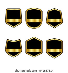 Set of black shields with Golden ribbons in trendy flat style isolated on white background. Herald logo and medieval Shield symbol for your web site design, logo. Vector illustration. EPS10.