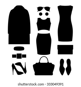 Set of black silhouette trendy women's clothes and accessories.Women's wardrobe. Vector illustration