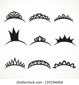 Set of black silhouettes of tiaras of various shapes on a white background