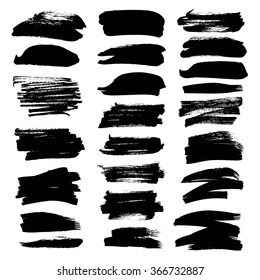 Set of black textured strokes drawn by flat brush isolated on a white background
