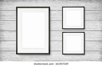 Set of blank frames on wooden vintage wall