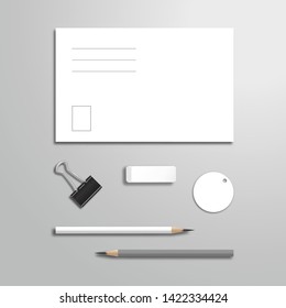Set of blank white postcard, pencils, memo, eraser and binder. Top view mockup template with shadow