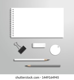 Set of blank white spiral notebook or album, pencils, memo, eraser and binder. Top view mockup template with shadow