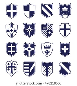 Set of blue heraldic shields with emblems isolated on white background. Vector illustration.