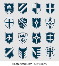 Set of blue heraldic shields with emblems on neutral background. Vector illustration.