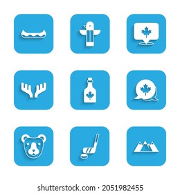 Set Bottle of maple syrup, Ice hockey stick and puck, Mountains, Canadian leaf, Bear head, Deer antlers,  and Kayak icon. Vector
