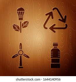 Set Bottle of water, Light bulb with leaf, Wind turbine and Recycle symbol on wooden background. Vector