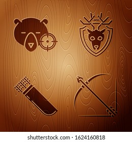 Set Bow and arrow in quiver, Hunt on bear with crosshairs, Quiver with arrows and Deer head with antlers on shield on wooden background. Vector