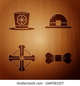 Set Bow tie, Leprechaun hat and four leaf clover, Celtic cross and Leprechaun hat on wooden background. Vector