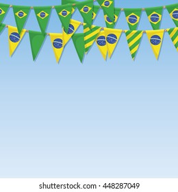 set of brazil flag bunting ornaments on blue background with copy space