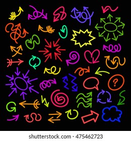 Set of bright hand drawn arrows of different colors isolated on black background. Vector illustration.