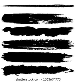 A set of brush strokes of black paint on a white background. Collection of abstract spots