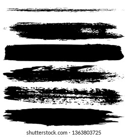 A set of brush strokes of black paint on a white background. Collection of abstract spots