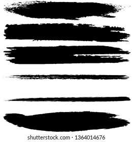 A set of brush strokes of black paint on a white background. Collection of abstract spots